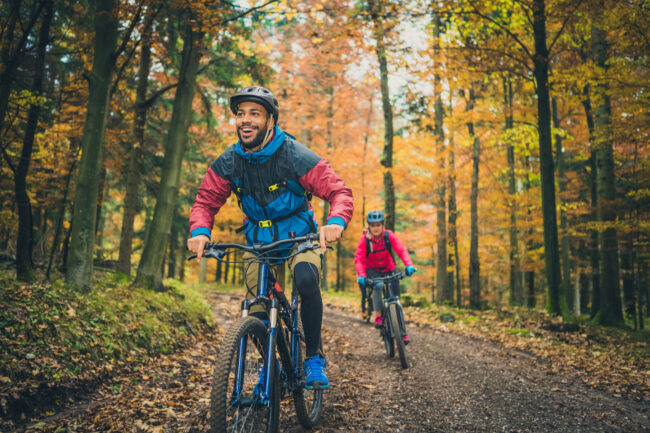 Smiling young black man enjoying sport with friends in nature